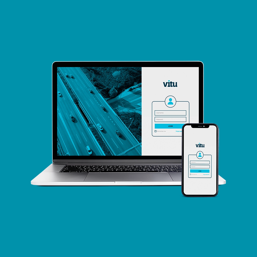 Um notebook junto com um celular, ambos com uma interface de login da empresa Vitu caracteristica pela cor azul-ciano